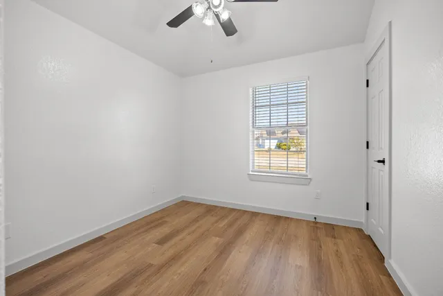 wooden floor in an empty room with a window