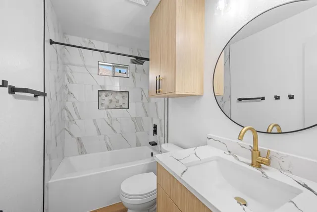 a bathroom with a sink toilet and shower