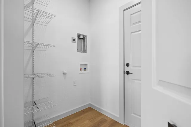 a view of a room with wooden floor