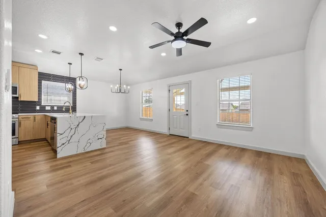a view of a kitchen with furniture and wooden floor