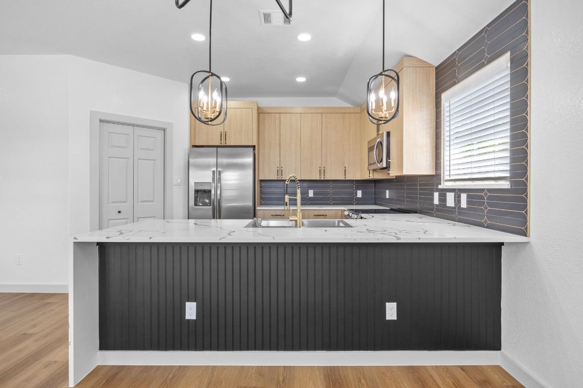2303 Thomas Street Taylor, TX 76574 - Photo 5 of 16 a bathroom with a sink a mirror and a window