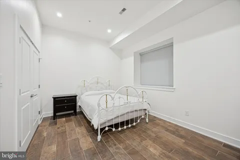 a spacious bedroom with a bed and a cabinets