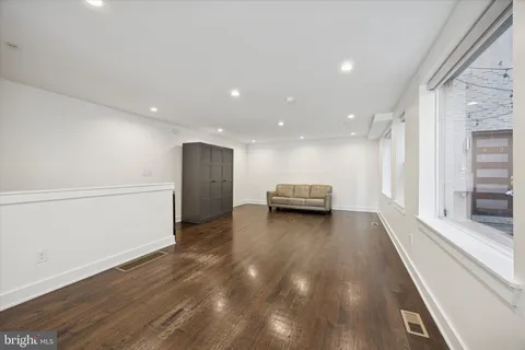 a view of kitchen with stove and refrigerator