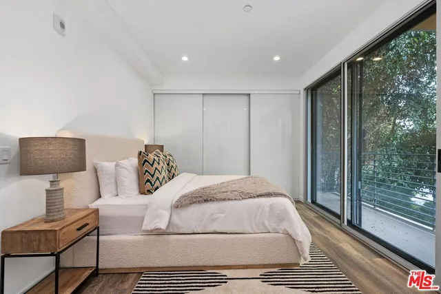 a bedroom with a large bed and a couch