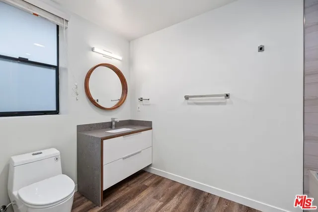 a bathroom with a toilet a sink and a mirror