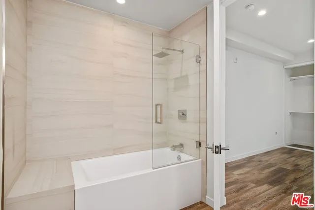 a bathroom with a bathtub and a shower
