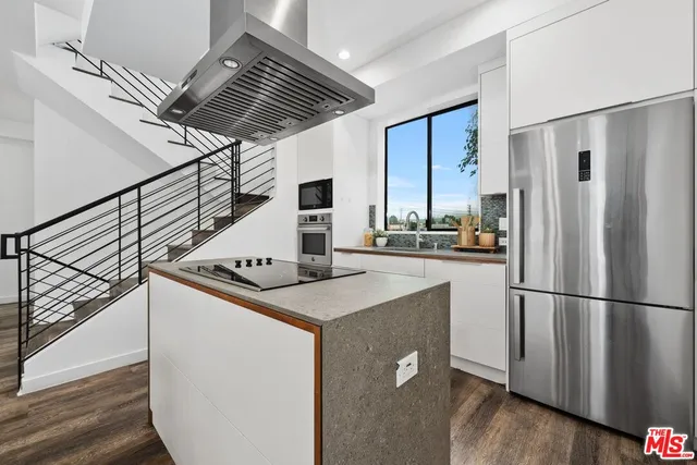 a kitchen with stainless steel appliances a refrigerator and a stove