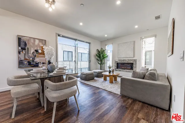 a living room with fireplace furniture and a large window