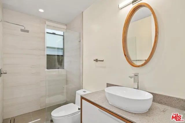 a bathroom with a sink toilet and a mirror