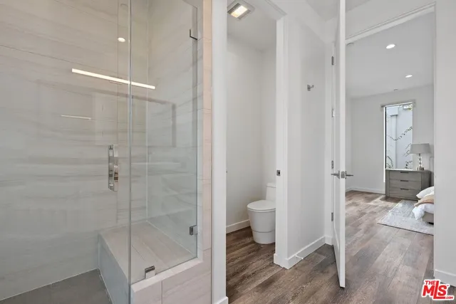 a bathroom with a shower and a toilet