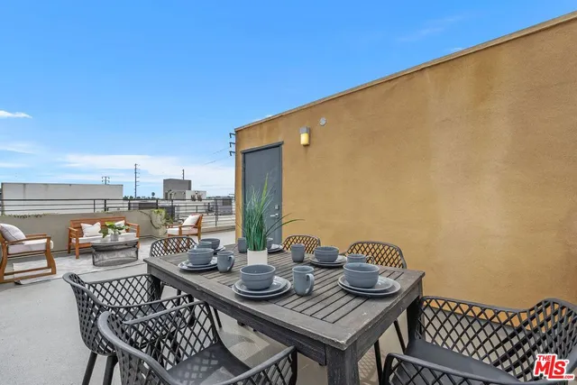 a view of a balcony dining table and chairs