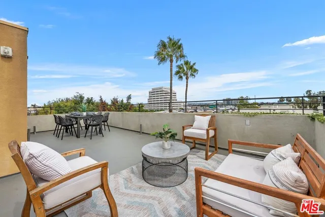 a view of a chairs and table in patio