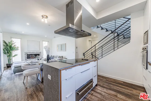 a kitchen with stainless steel appliances granite countertop a stove and cabinets