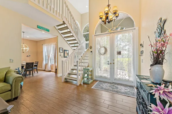 a living room with furniture a dining table with wooden floor