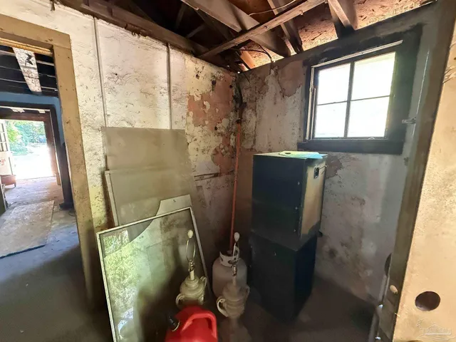 a bed sitting in a room next to a window