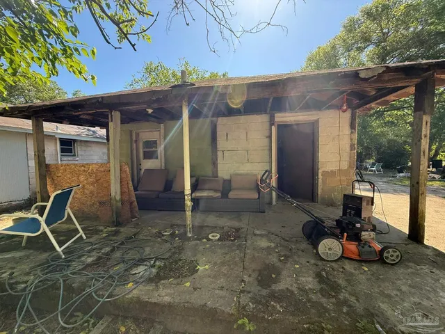 a backyard of a house with outdoor seating
