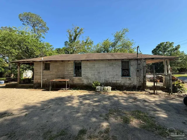 a backyard of a house with yard and outdoor seating