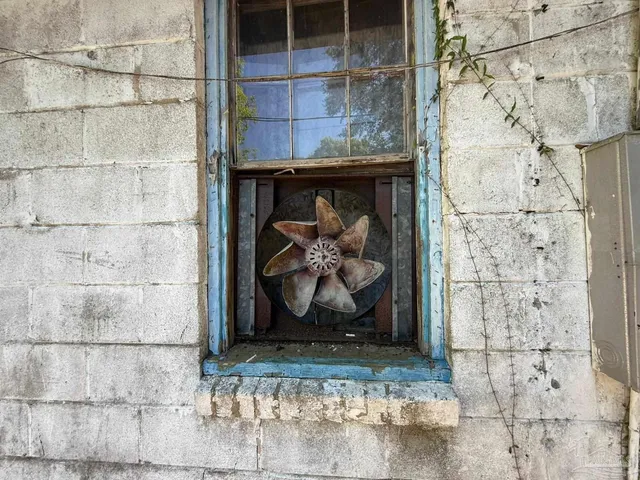 a bathroom with a shower and a tiled wall