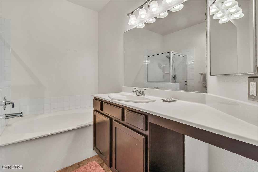 2050 West Warm Springs Road, Unit 1822 Henderson, NV 89014 - Photo 16 of 55 Primary Bathroom featuring tile patterned flooring, a bathtub, a shower stall, and vanity