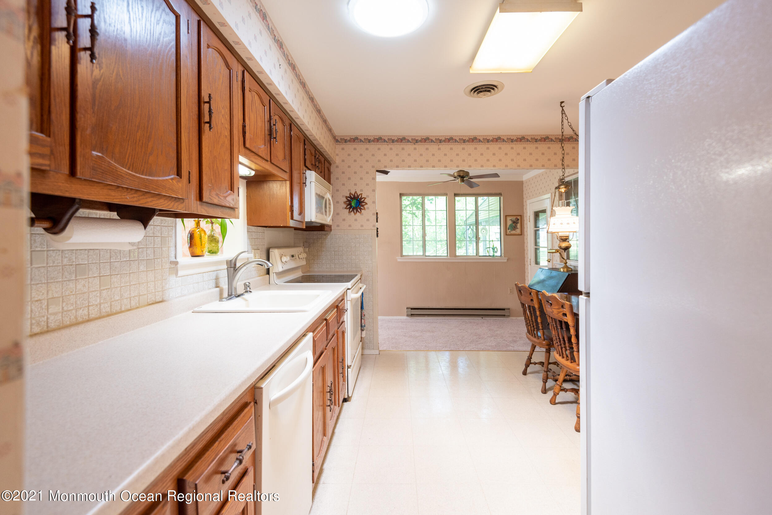 79 Sunset Road, Unit 61 Whiting, NJ 08759 - Photo 14 of 30 a kitchen with a sink stove and cabinets