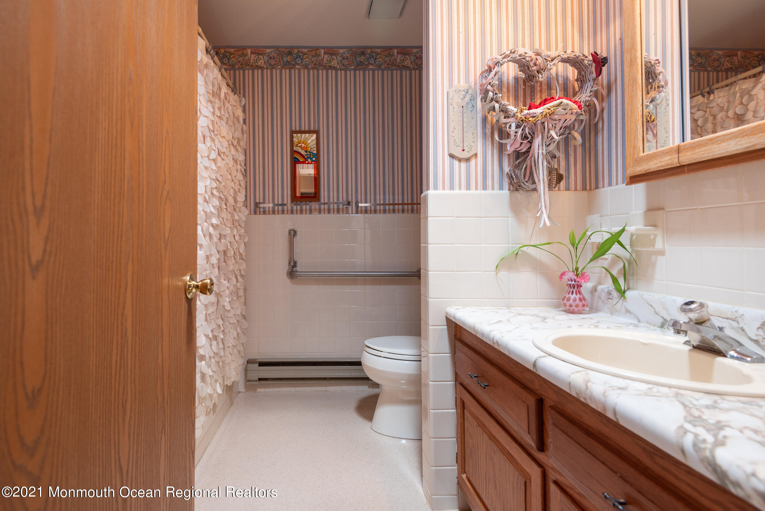 79 Sunset Road, Unit 61 Whiting, NJ 08759 - Photo 22 of 30 a bathroom with a granite countertop sink and a toilet