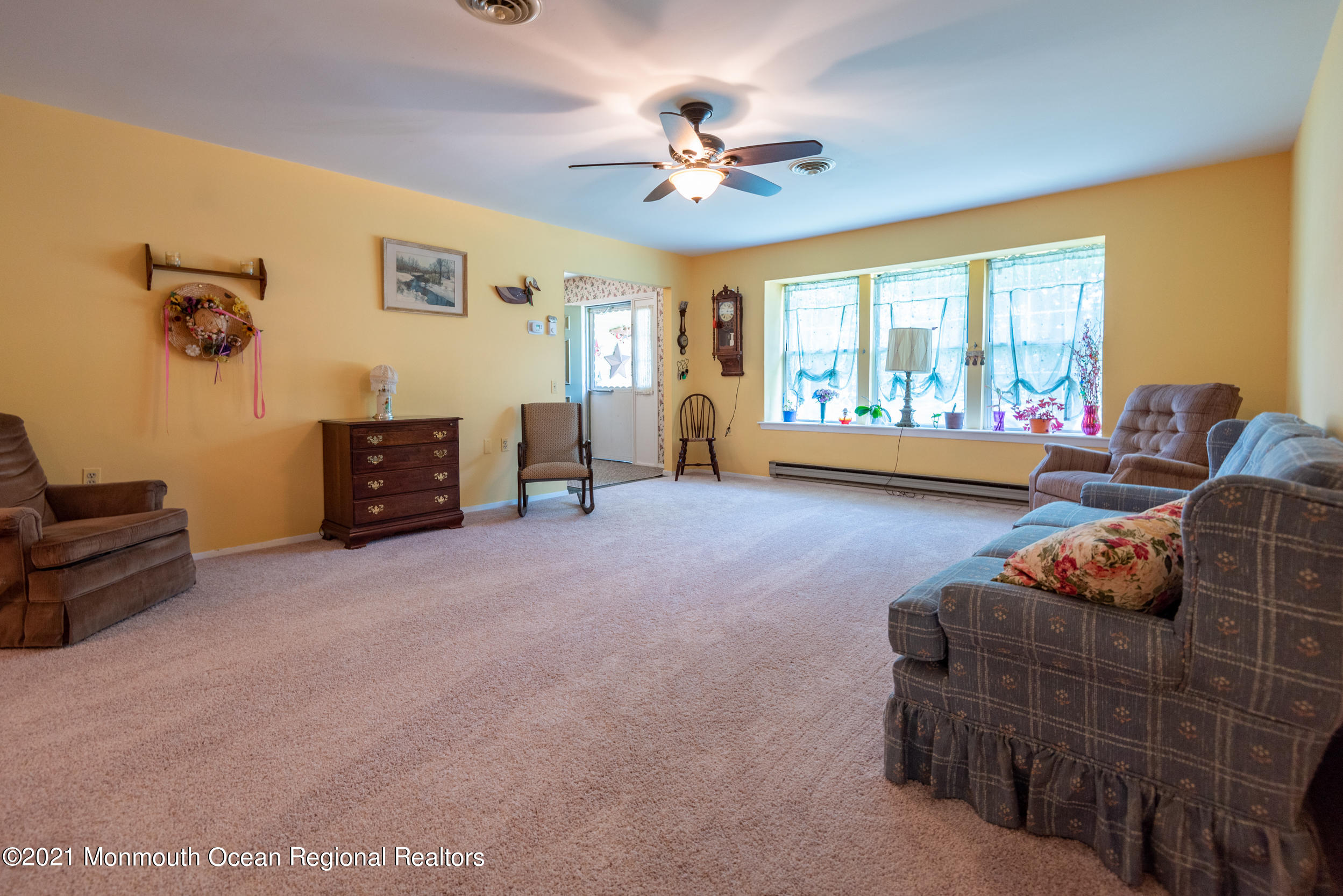 79 Sunset Road, Unit 61 Whiting, NJ 08759 - Photo 8 of 30 a living room with furniture and a chandelier