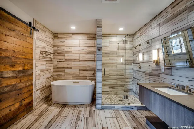 a bathroom with a sink a mirror and shower
