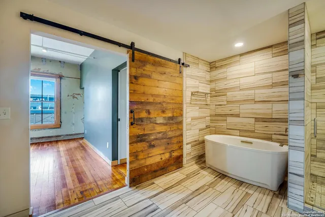 a bathroom with a shower and a sink