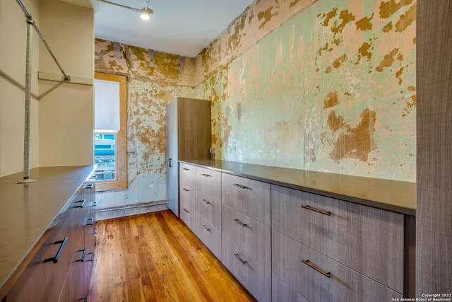 a bathroom with a granite countertop tub shower sink and mirror