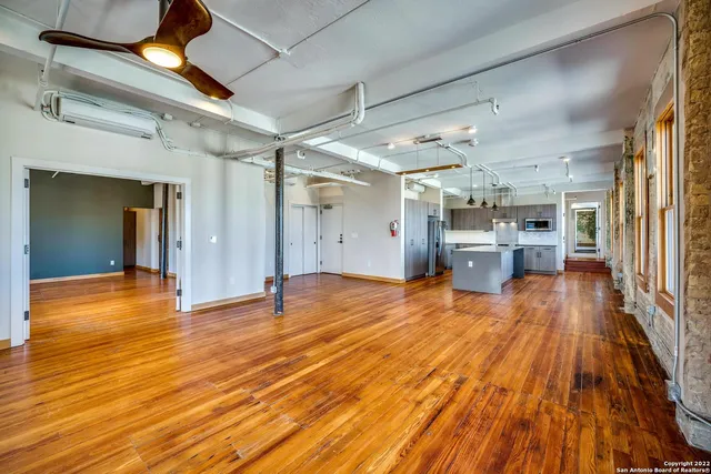 a view of empty room with wooden floor