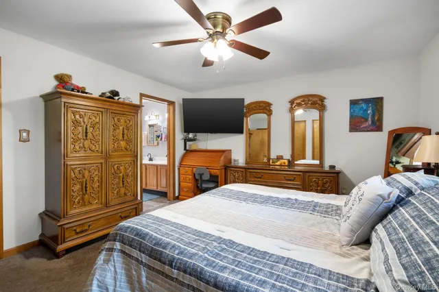 a bedroom with a bed dresser and a window