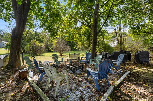a view of a patio with table and chairs under an umbrella