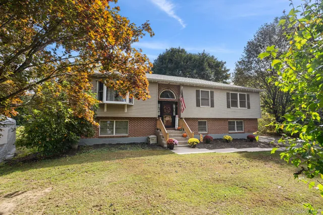 a view of a house with backyard porch and sitting area