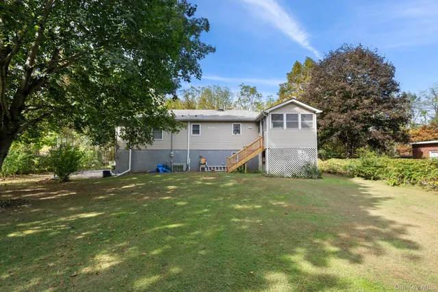 a front view of house with yard and green space