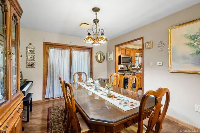 a view of a dining room with furniture and a chandelier
