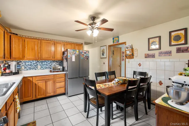 a kitchen with stainless steel appliances kitchen island granite countertop a table chairs in it and wooden floors