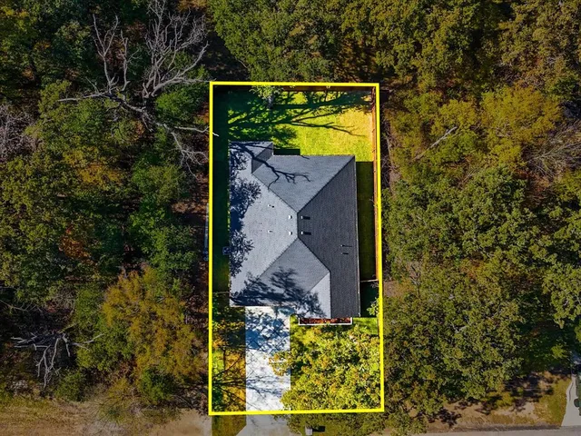 an aerial view of a house with a ocean view