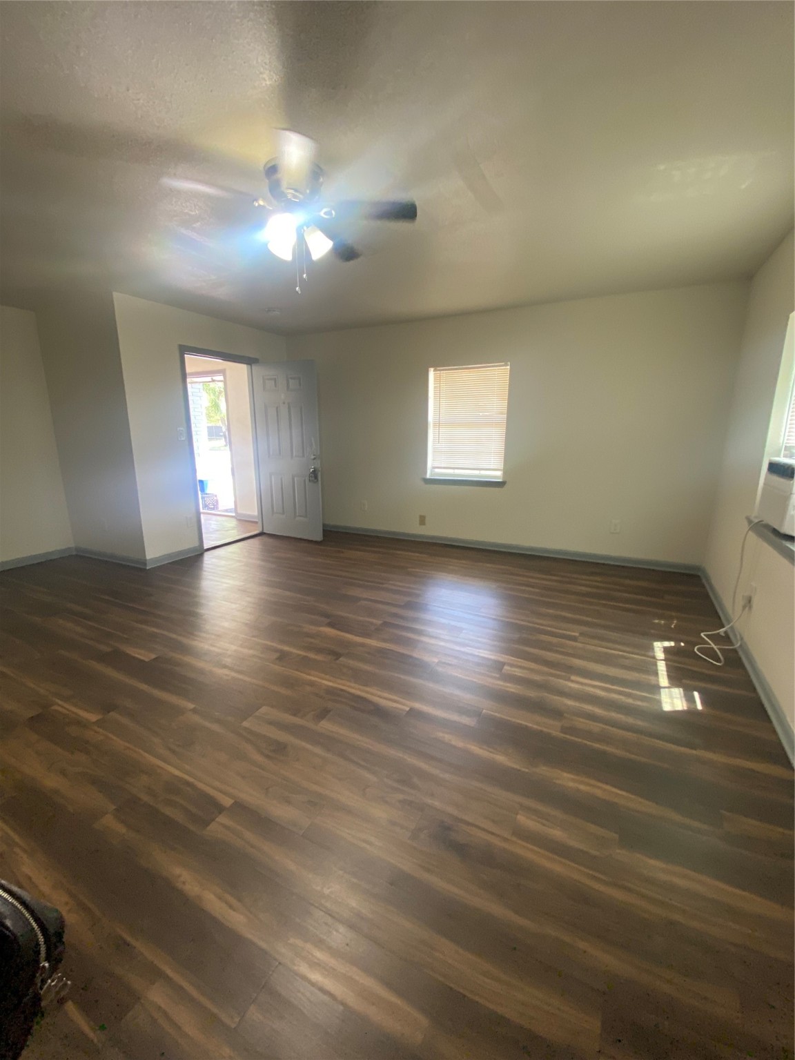 5301 Collingsworth Street, Unit 8 Houston, TX 77026 - Photo 4 of 8 an empty room with wooden floor and windows