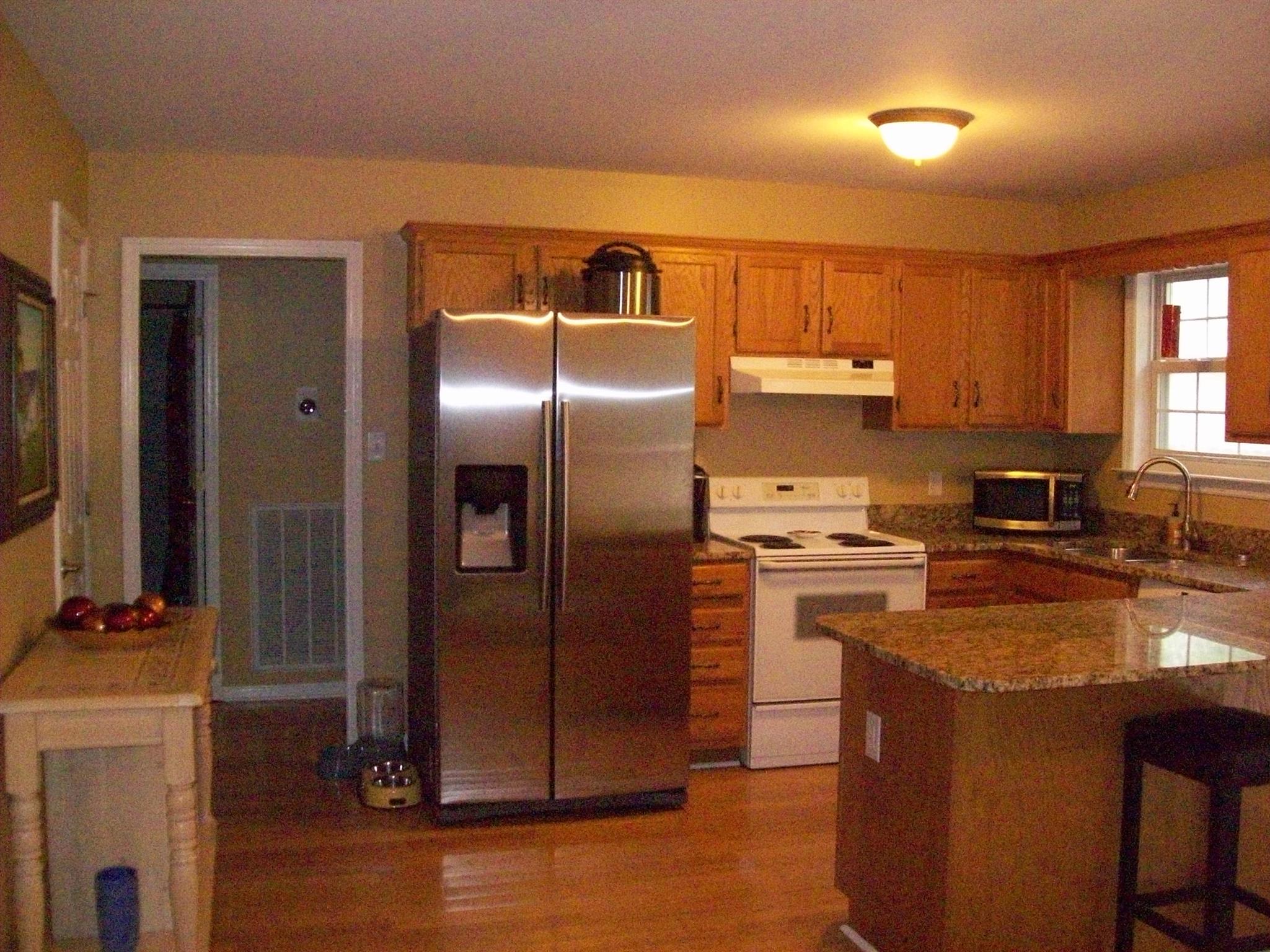 3637 Rutherford Drive Spring Hill, TN 37174 - Photo 9 of 25 a kitchen with granite countertop a refrigerator and a stove top oven
