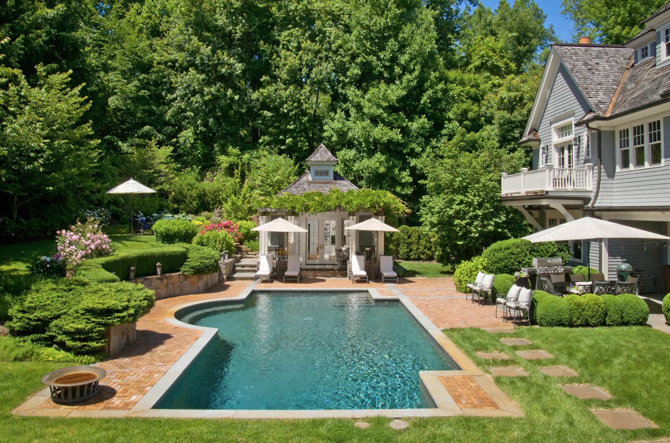 3 Hycliff Road Greenwich, CT 06831 - Photo 26 of 31 a front view of a house with a yard table and chairs
