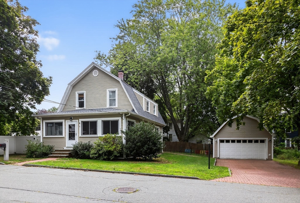 8 Corthell Road North Billerica, MA 01862 - Photo 1 of 28 a front view of a house with a yard and garage