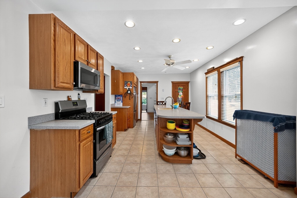 8 Corthell Road North Billerica, MA 01862 - Photo 6 of 28 a kitchen with stainless steel appliances granite countertop sink stove and refrigerator