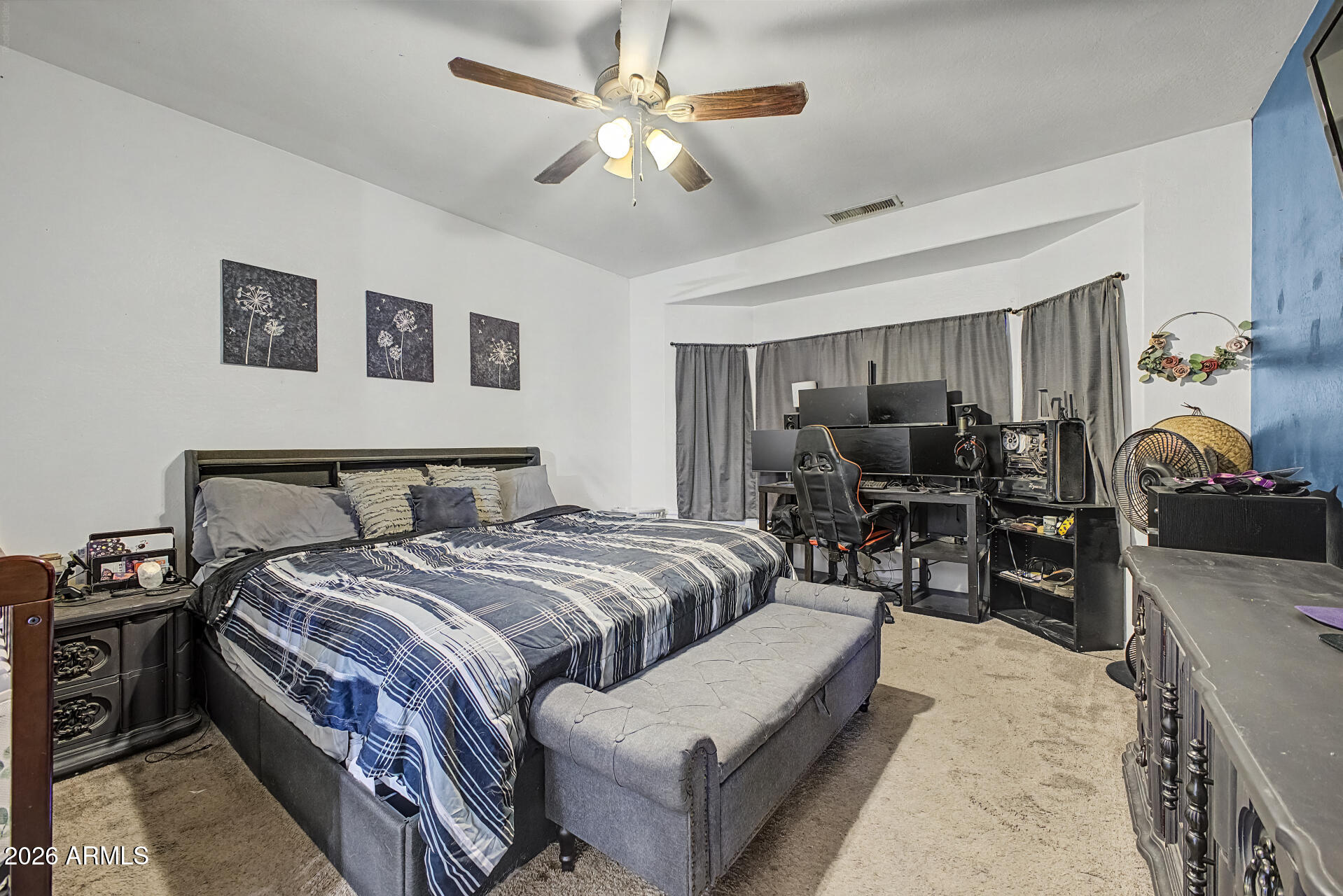 5301 West Grenadine Road Laveen, AZ 85339 - Photo 16 of 37 a bedroom with bed and a chandelier