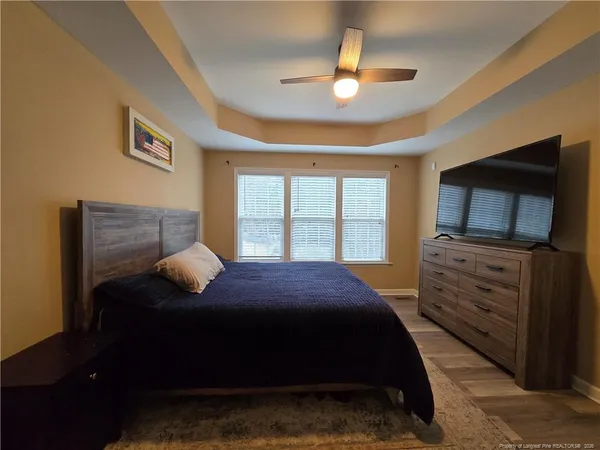 a bedroom with a bed and a television