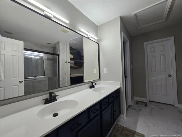 a bathroom with a double vanity sink mirror and double