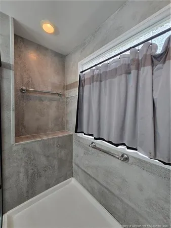 a bathroom with a shower and a tub