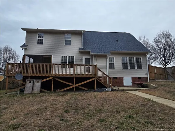a backyard of a house with wooden deck and deck