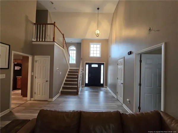 a view of gallery with stairs and wooden floor