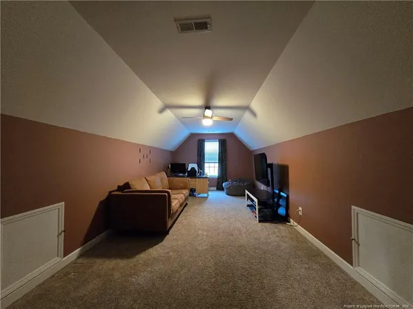 a view of a livingroom with furniture and a ceiling fan