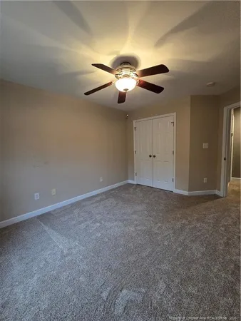a view of a room with a ceiling fan